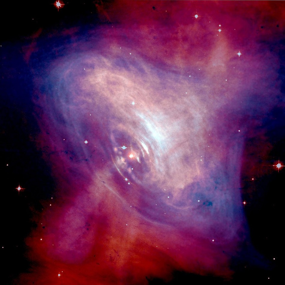 Pulsar Krabí mlhoviny na snímku složeném z viditelného a rentgenového záření, Optical: NASA/HST/ASU/J. Hester et al. X-Ray: NASA/CXC/ASU/J. Hester et al. [Public domain or Public domain], via Wikimedia Commons.